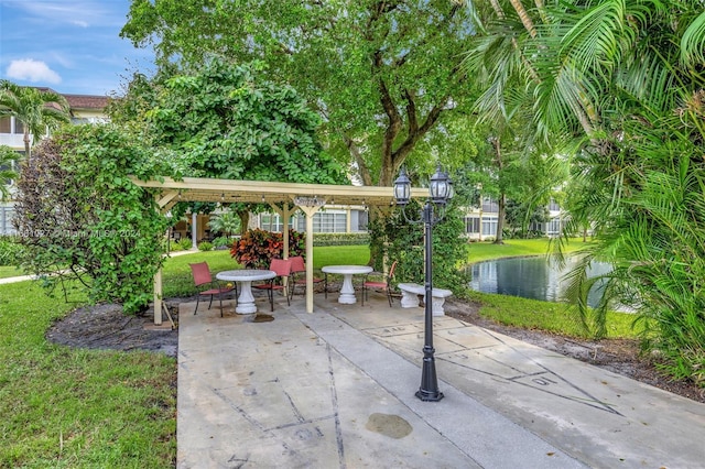 view of patio / terrace with a water view and a pergola