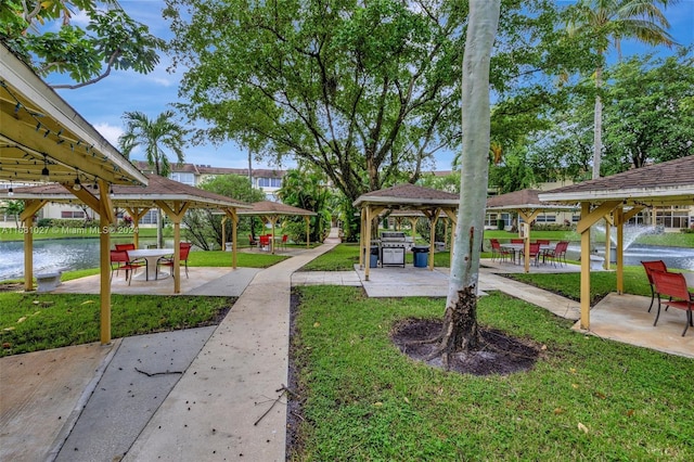 view of property's community featuring a gazebo, a yard, and a water view