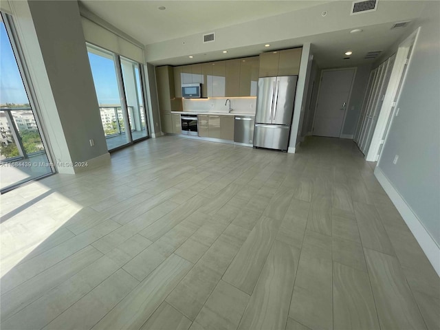 unfurnished living room with light hardwood / wood-style floors and sink