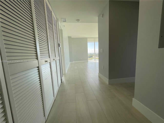 hallway with light tile patterned flooring