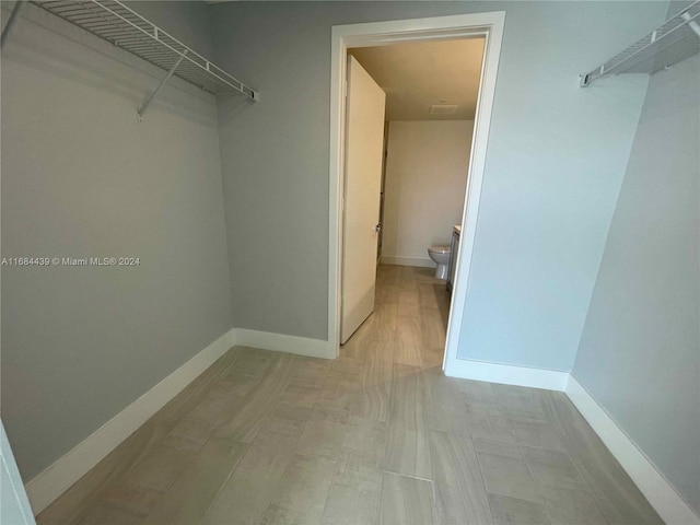 spacious closet with light hardwood / wood-style flooring