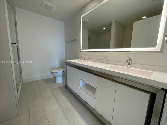 bathroom with toilet, walk in shower, vanity, and tile patterned floors