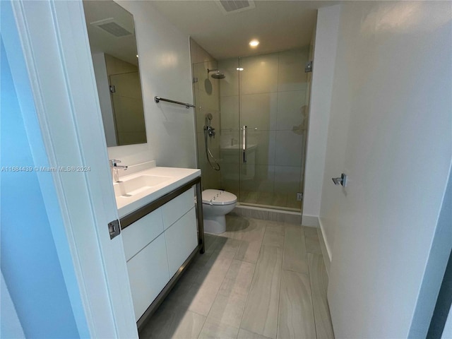 bathroom with toilet, an enclosed shower, and vanity