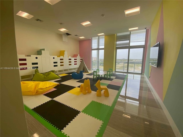 playroom with tile patterned floors and floor to ceiling windows