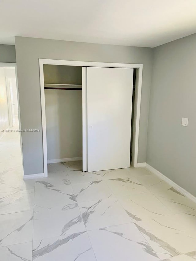 unfurnished bedroom with a closet