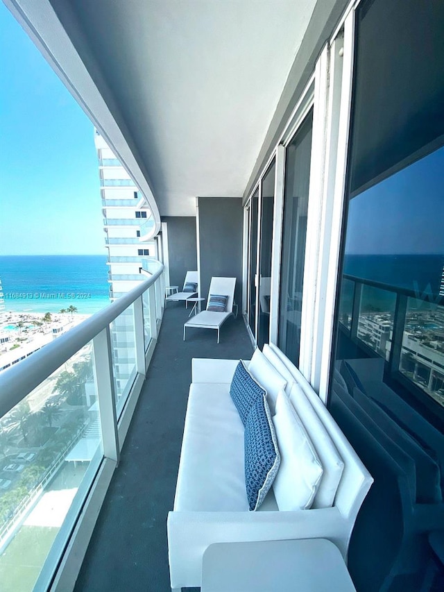 balcony with a water view and a beach view