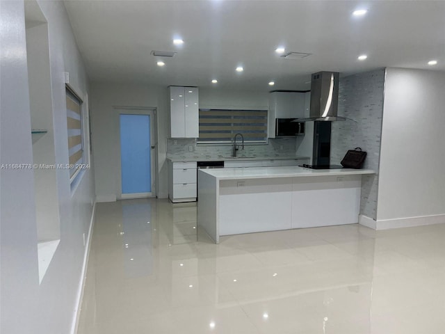 kitchen with decorative backsplash, white cabinets, light tile patterned floors, island range hood, and sink