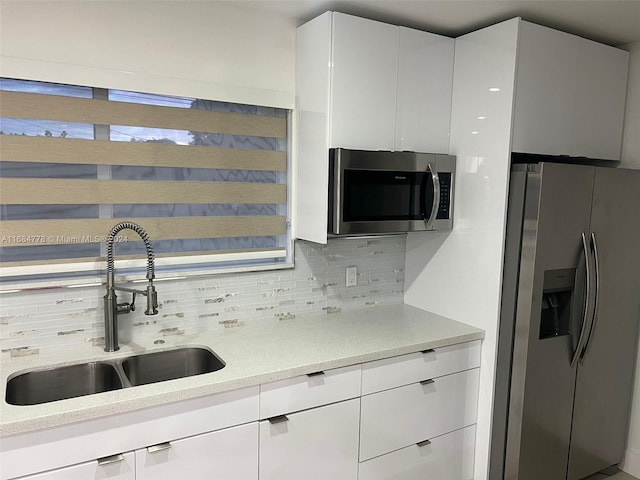 9520 Lisa Rd, Cutler Bay, FL 33157 - kitchen featuring modern cabinets, a sink, backsplash, white cabinets, and appliances with stainless steel finishes
