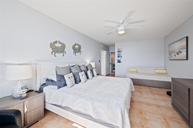 tiled bedroom with a textured ceiling and ceiling fan