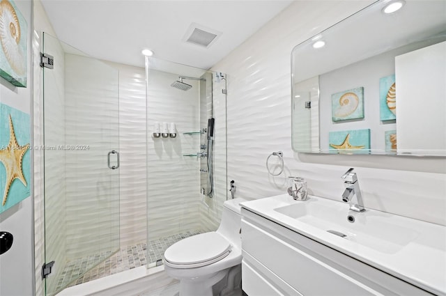 bathroom featuring vanity, hardwood / wood-style flooring, toilet, and an enclosed shower