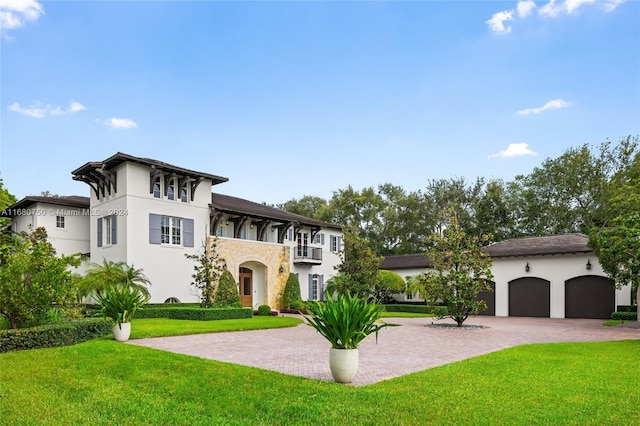 view of front of property featuring a balcony, a front yard, a garage, and cooling unit