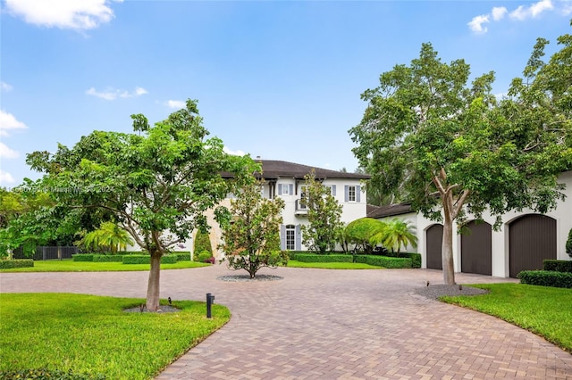 view of front of property featuring a garage and a front lawn