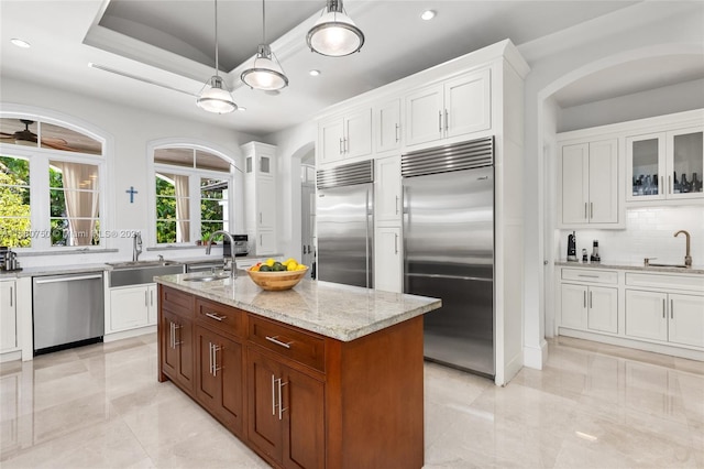 kitchen featuring appliances with stainless steel finishes, sink, and a center island with sink