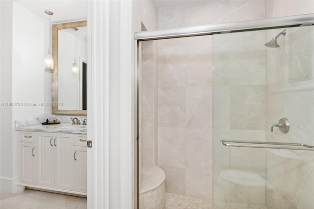 bathroom featuring vanity, tile patterned floors, and walk in shower