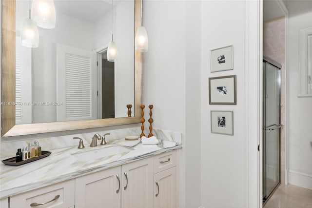 bathroom featuring vanity and a shower with shower door