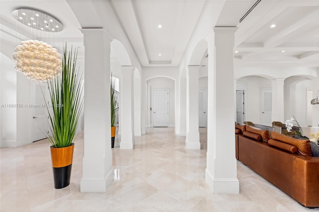 foyer with decorative columns and a chandelier