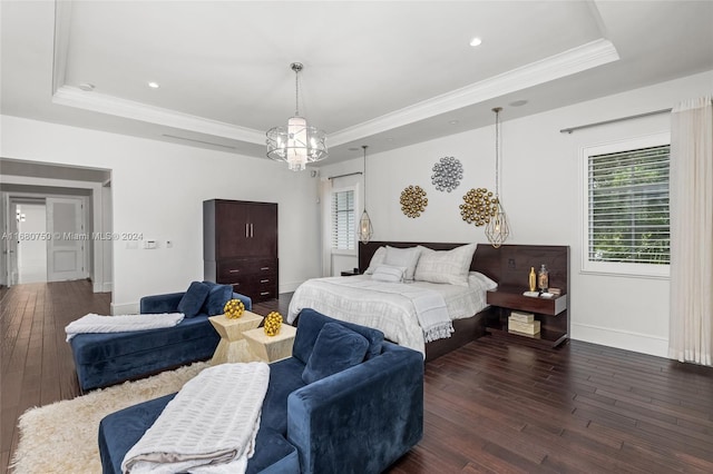 bedroom with dark wood-type flooring, a raised ceiling, and ornamental molding