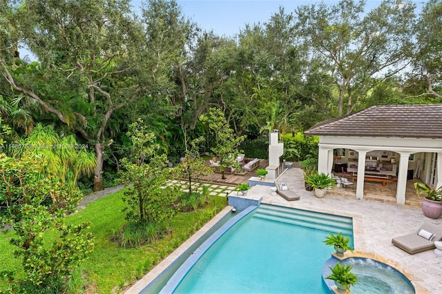 view of swimming pool with a patio and an in ground hot tub