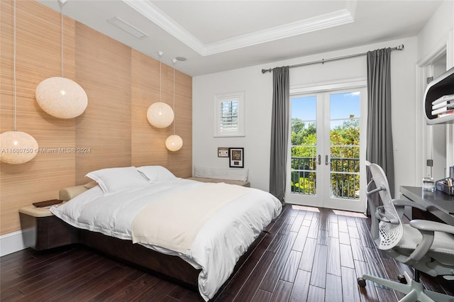 bedroom with french doors, a raised ceiling, dark hardwood / wood-style flooring, and access to exterior