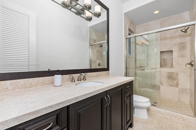 bathroom featuring vanity, tile patterned floors, toilet, and walk in shower