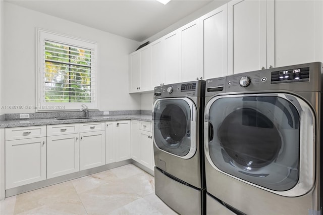 washroom with sink, washer and clothes dryer, and cabinets