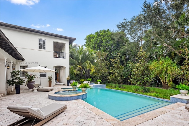 view of swimming pool with a patio and an in ground hot tub