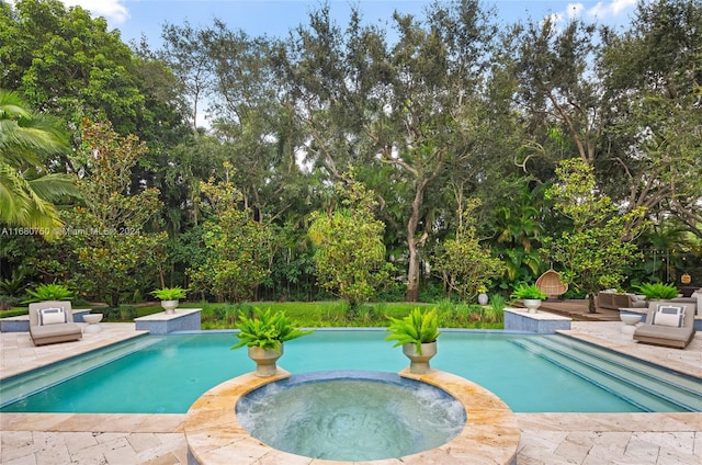 view of swimming pool with an in ground hot tub and a patio