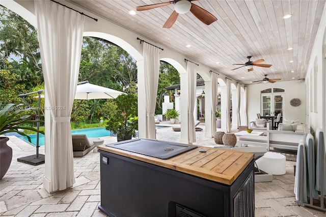 view of patio / terrace with an outdoor living space, a pool with hot tub, and ceiling fan