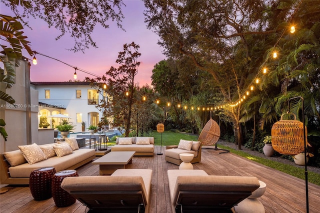 deck at dusk featuring outdoor lounge area