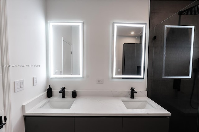 bathroom with vanity and a shower with shower door