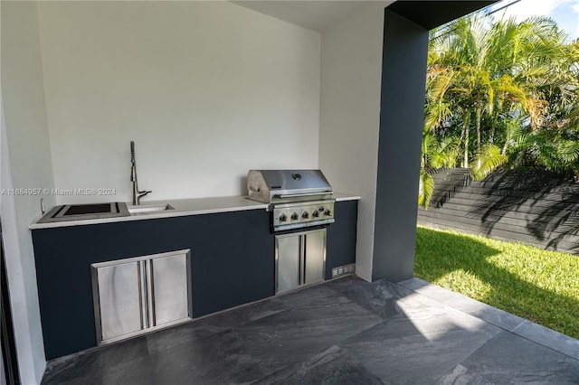 view of patio with an outdoor kitchen and a grill