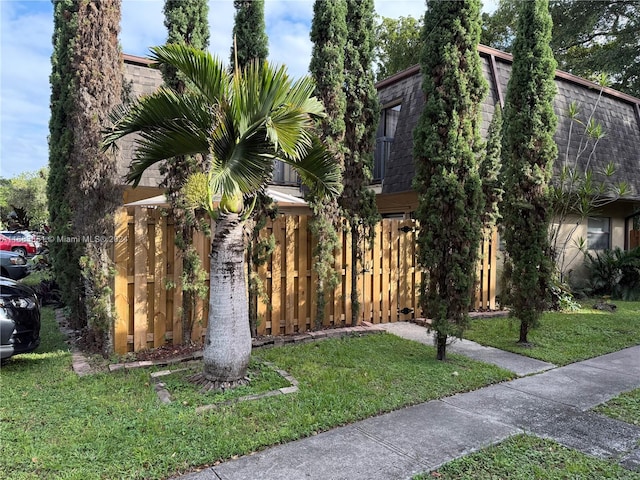 view of side of home featuring a lawn