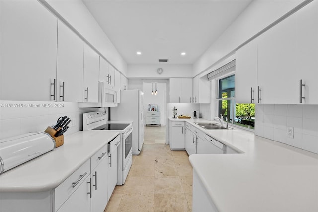 kitchen featuring white appliances, white cabinetry, sink, and decorative backsplash