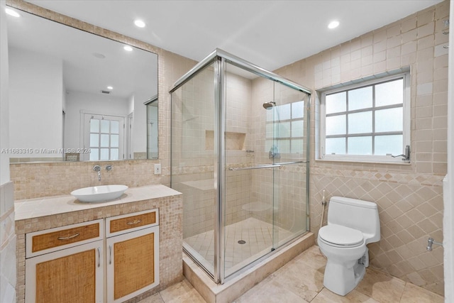 bathroom featuring vanity, toilet, tile walls, and an enclosed shower