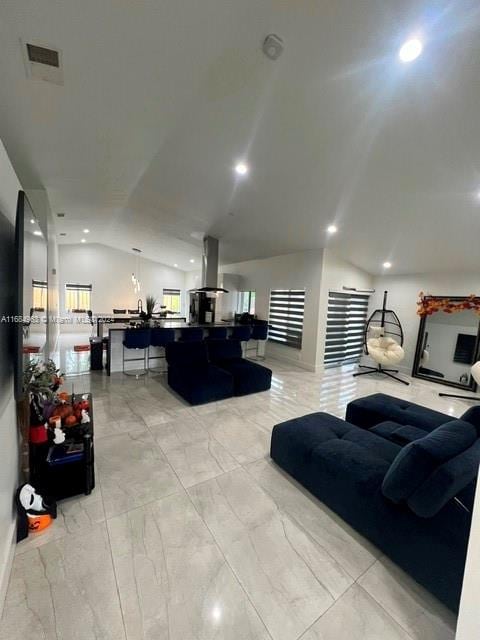 living room featuring lofted ceiling