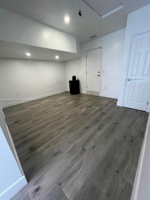 basement featuring dark hardwood / wood-style floors