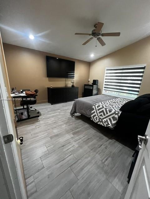 bedroom with ceiling fan and wood-type flooring