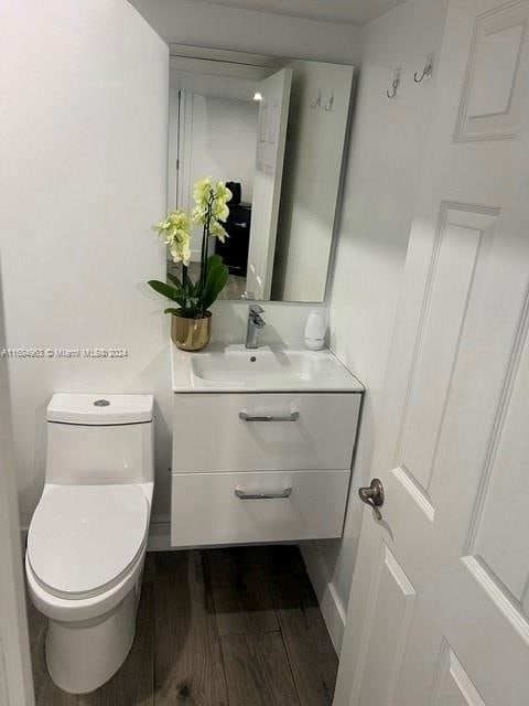 bathroom featuring vanity, toilet, and wood-type flooring