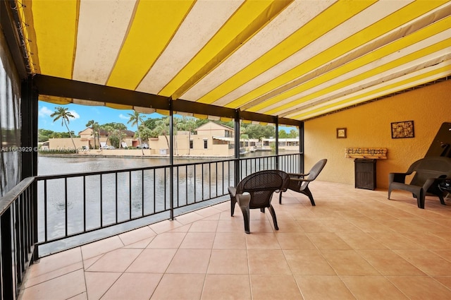 15442 Kippford Ct, Miami Lakes, FL 33014 - sunroom featuring expansive windows, tile patterned floors, a water view, vaulted ceiling with beams, and a textured wall