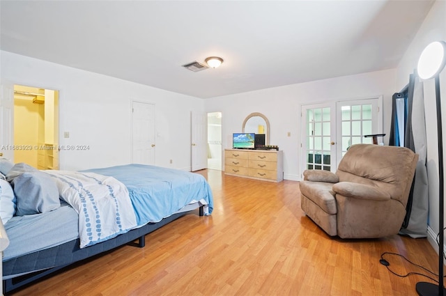 15442 Kippford Ct, Miami Lakes, FL 33014 - bedroom featuring visible vents, connected bathroom, light wood-style floors, and french doors