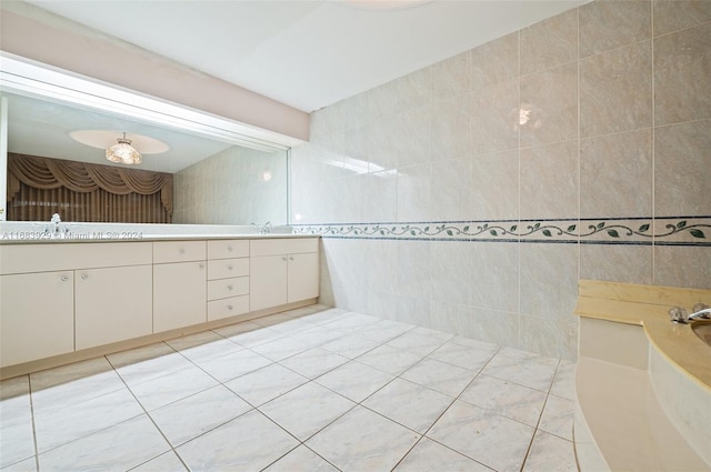 bathroom featuring vanity, tile patterned floors, and tile walls