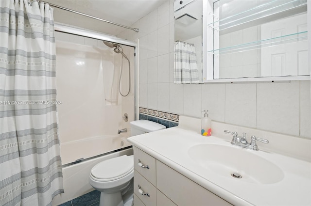 full bathroom featuring vanity, shower / tub combo with curtain, toilet, and tile walls