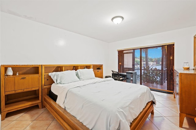 tiled bedroom featuring access to outside