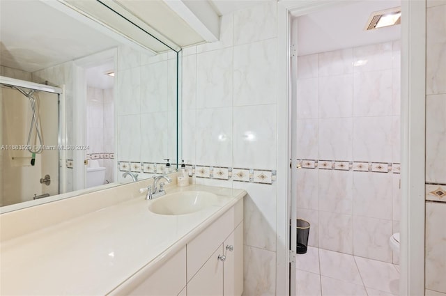15442 Kippford Ct, Miami Lakes, FL 33014 - bathroom featuring vanity, tile walls, a shower stall, and toilet