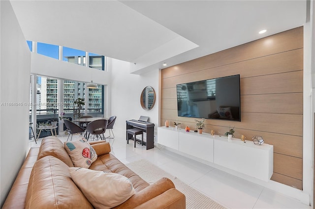 living area with recessed lighting, wooden walls, and light tile patterned floors