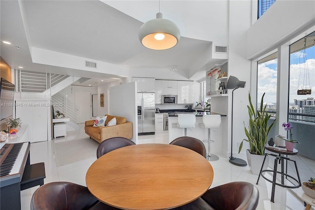 dining room featuring light tile patterned floors, stairs, visible vents, and recessed lighting