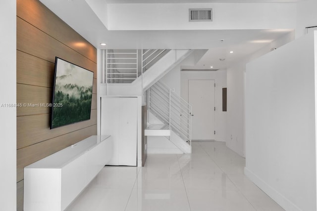 stairway with baseboards, visible vents, and recessed lighting