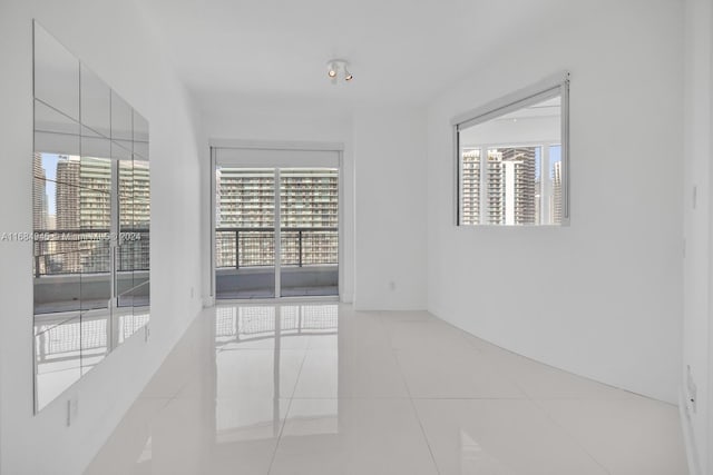 tiled spare room with plenty of natural light