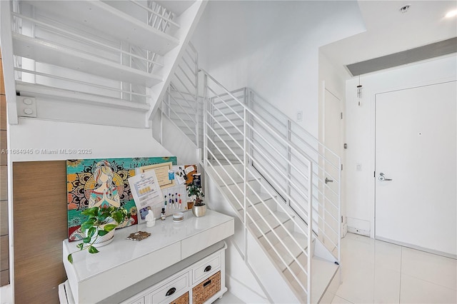 stairway featuring tile patterned floors