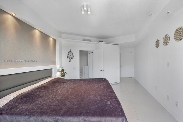 full bathroom featuring tile patterned flooring, vanity, toilet, and tiled shower / bath combo